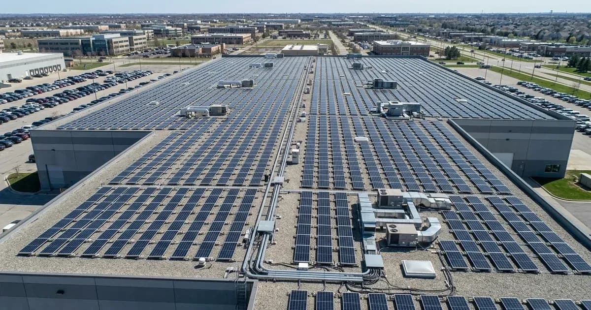 Expansive commercial rooftop solar panel array installed on an industrial warehouse building. — SolarNevs spec card