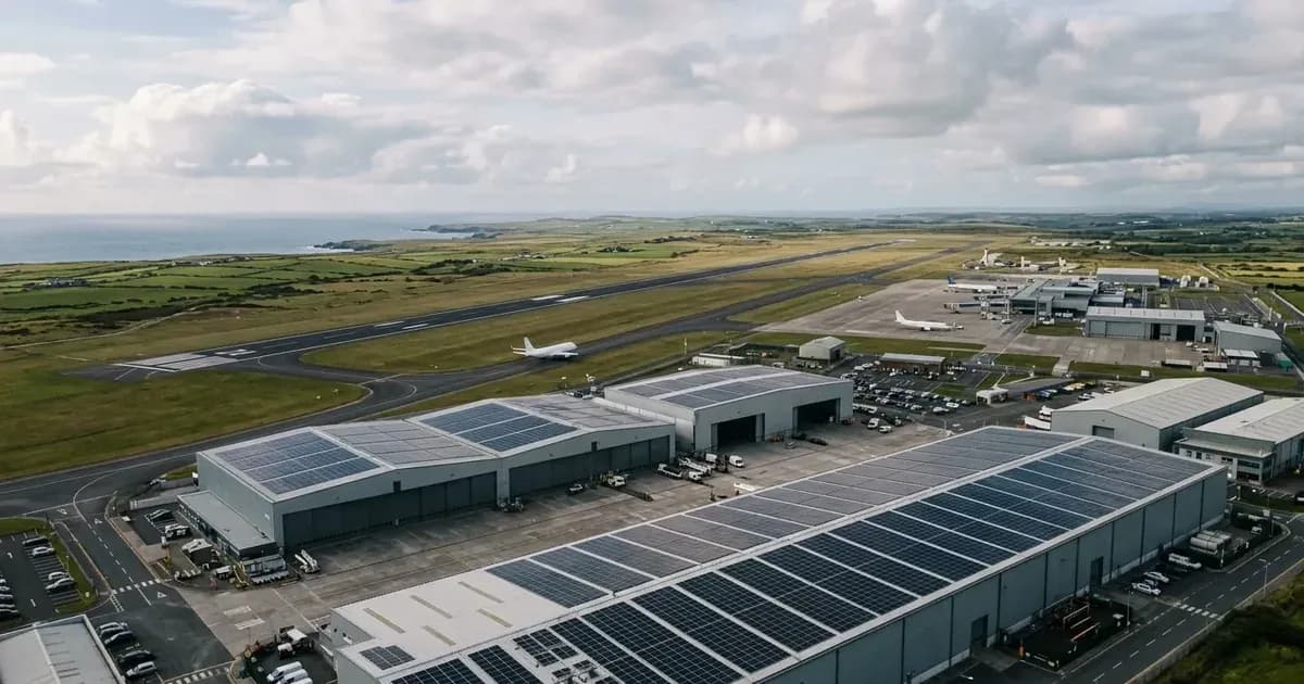 Aerial view of rooftop solar panel arrays on hangars adjacent to an airport runway in Ireland. — SolarNevs spec card